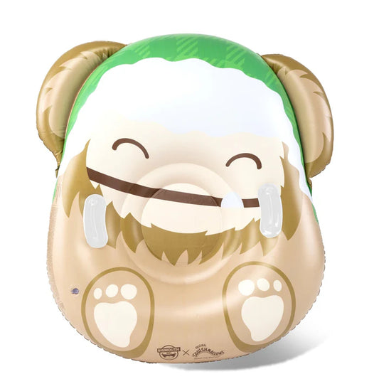 A large, inflatable snow tube designed to look like Benny the Big Foot Squishmallow, featuring his brown face, green plaid hat, and smiling mouth with one tooth