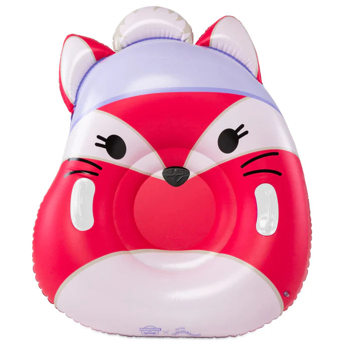 A large, inflatable snow tube designed to look like Fifi the Fox Squishmallow, featuring her red and white fox face, a purple winter hat with a white pom-pom, and two sturdy side handles.