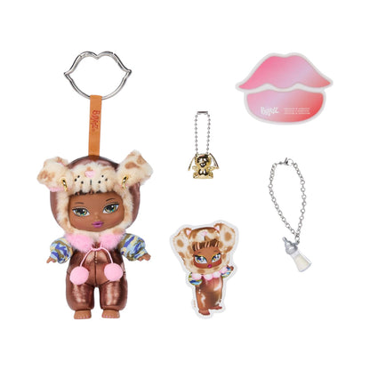 A doll keychain set featuring a brown doll in a furry animal hood with pink pom-poms, a small gold dog charm on a ball chain, a pink lips-shaped sticker, and a silver chain with a bottle-shaped charm, all on a white background.