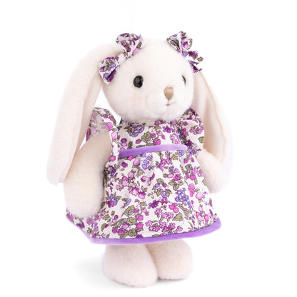 Bukowski Bears Dalia white plush bunny wearing a violet floral dress with ruffled sleeves and matching bows on her floppy ears.