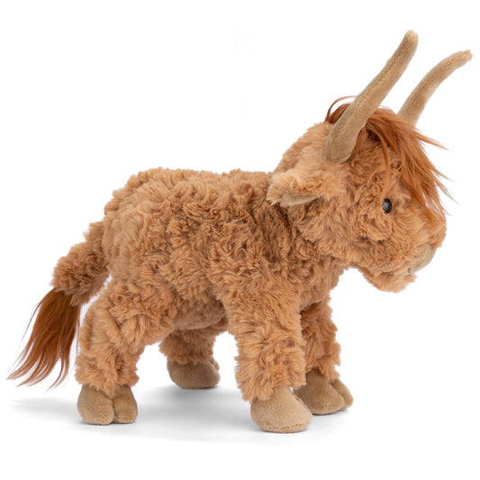 Bukowski Bears Henderson 12-inch highland cow plush sitting in the grass, featuring shaggy warm earthy-toned fur and curved horns.