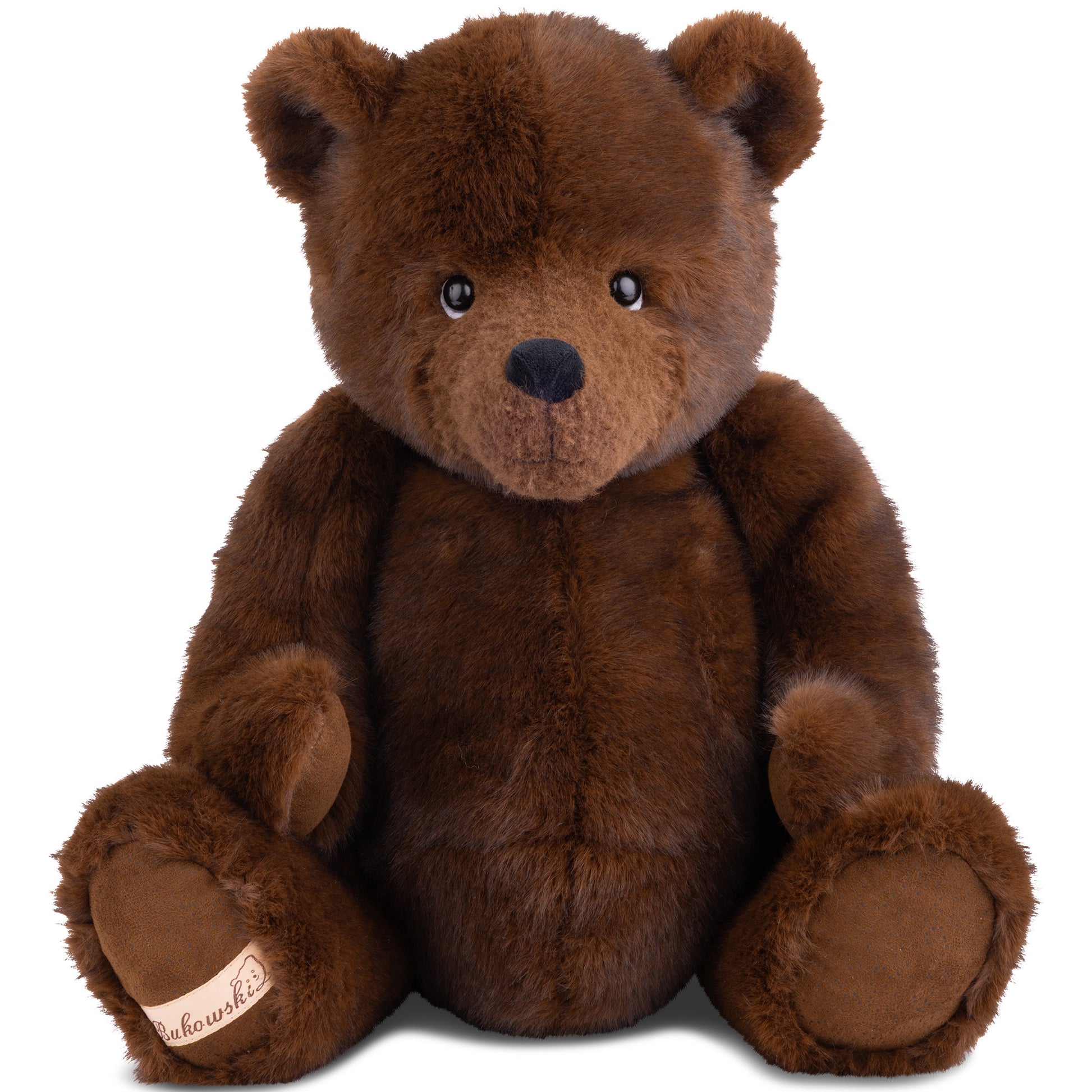 Bukowski Bears John My Treasure plush sitting upright featuring soft dark brown fur and a signature Bukowski logo patch on his foot.