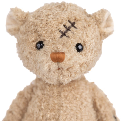 Bukowski Bears Nobody is Perfect plush bear featuring a stitched scar on the head, a red patch on the belly, and embroidered footpads.