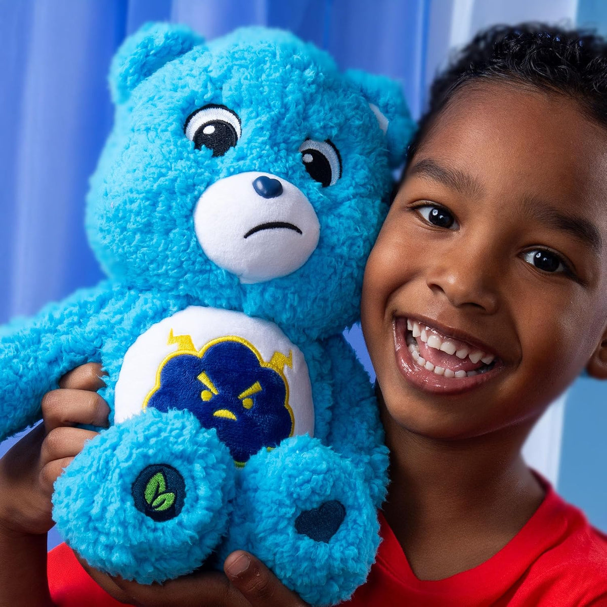 Care Bears Cozy Grumpy Bear soft blue sherpa plush stuffed toy featuring a frowning expression and a thunderstorm cloud belly badge.
