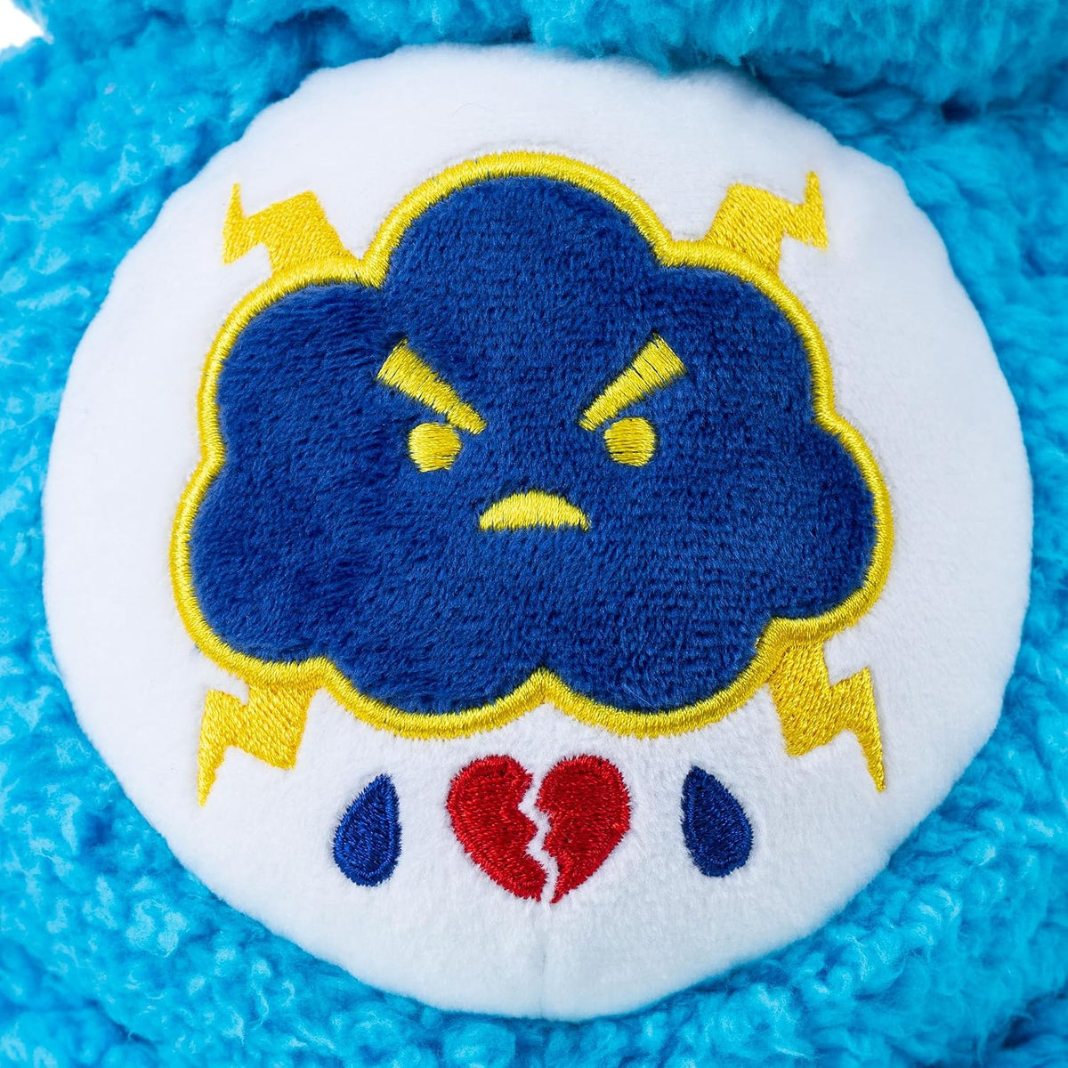 Care Bears Cozy Grumpy Bear soft blue sherpa plush stuffed toy featuring a frowning expression and a thunderstorm cloud belly badge.