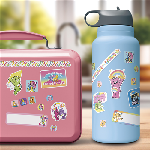 Pink lunch box and blue water bottle with cartoon character stickers on a blurred background
