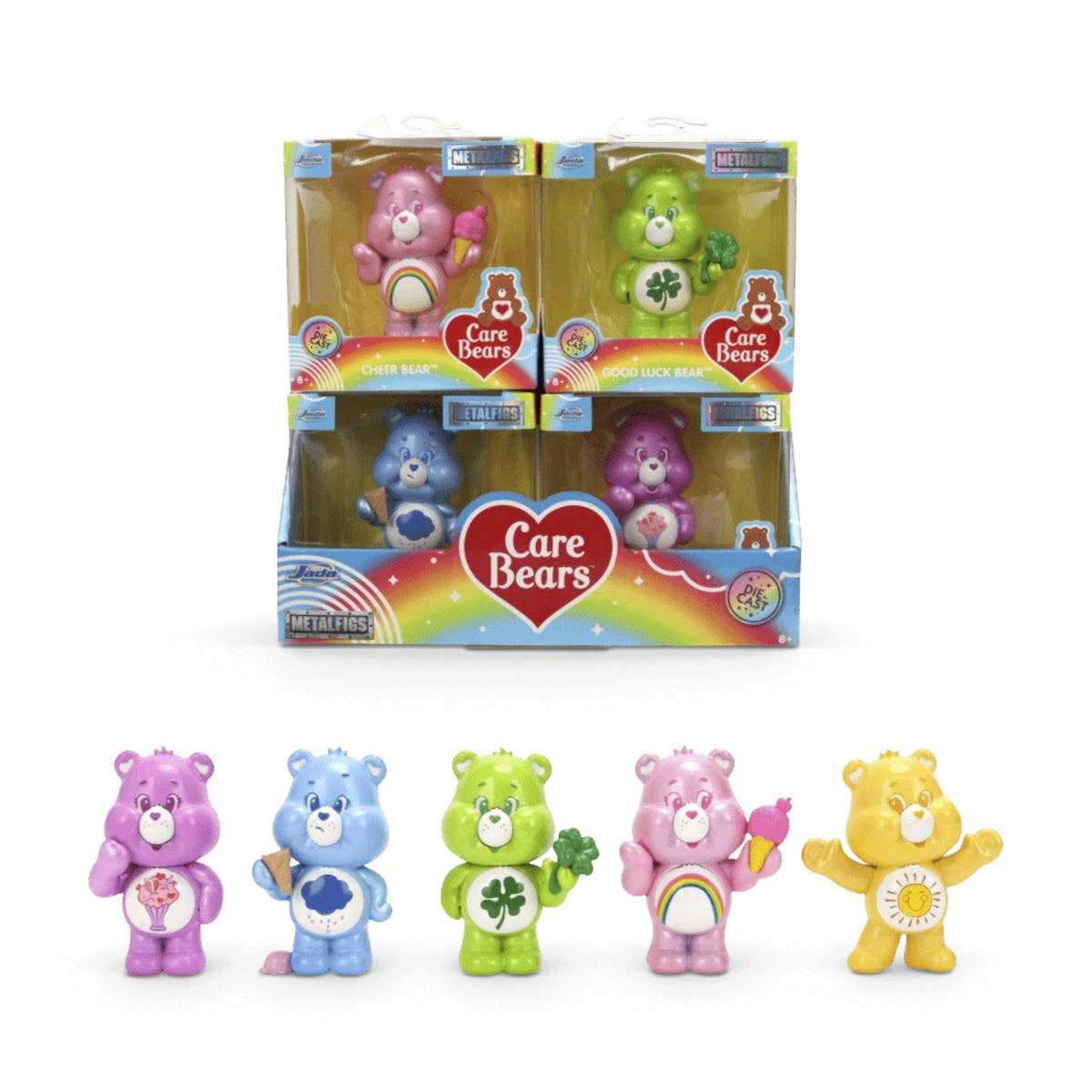 Five Jada Toys Metalfigs Care Bears toy bear figures displayed in front of their retail packaging on a white background. The set includes a pink bear with a rainbow, a blue bear with a bowtie, a green bear with a shamrock, a pink bear holding a rainbow, and a yellow bear with a sun face, alongside a multi-pack display box.