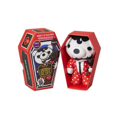 Toy bear in a coffin-shaped box with a red lid on a white background