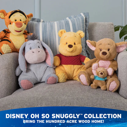 Plush toys including Tigger, Pooh, Eeyore, and Piglet on a couch with 'Disney Oh So Snuggly Collection' text.