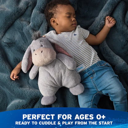 Child sleeping with a plush toy on a blue blanket, with text indicating it's suitable for ages 0+.