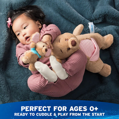 Baby holding two teddy bears with a blue blanket underneath, text indicating suitability for ages 0+