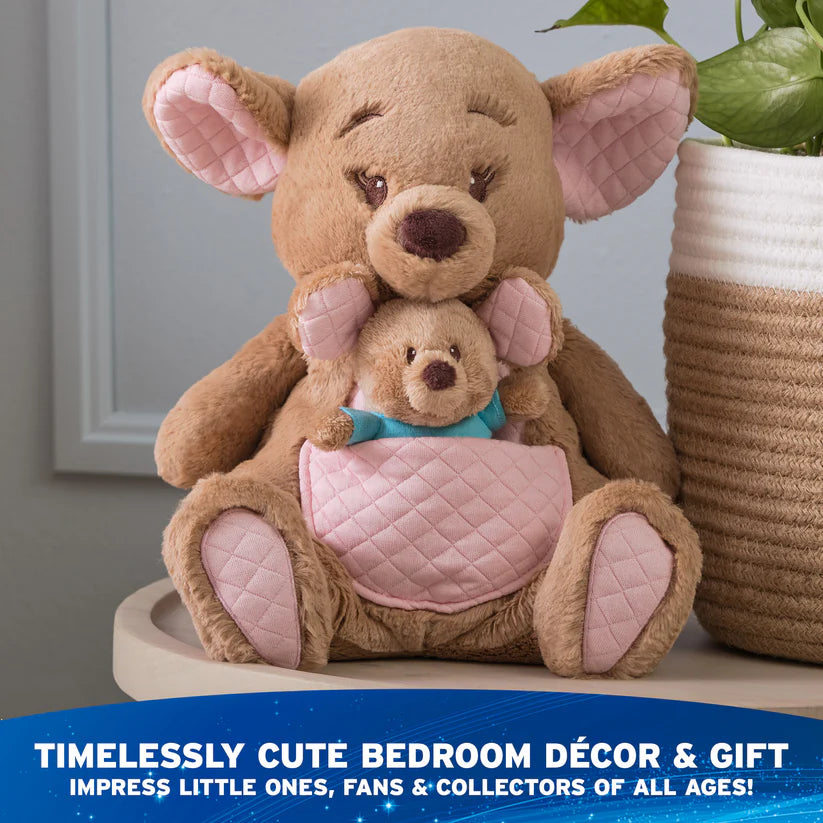 Disney GUND Oh So Snuggly Kanga and Roo 12.5-inch plush, a brown kangaroo with a removable joey in her pouch., on a surface with a plant in the background.