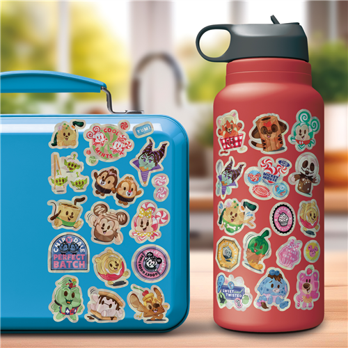 Blue lunch box and red water bottle with cartoon character stickers on a blurred outdoor background