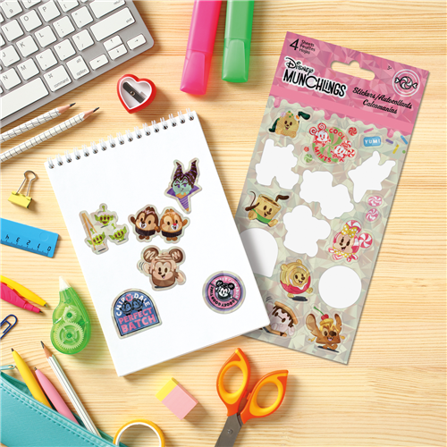 Sheet of Disney stickers on a desk with stationery items