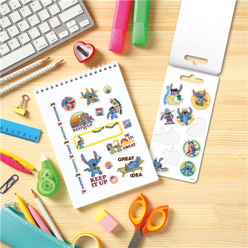 Sticker book with cartoon characters on a desk with stationery items