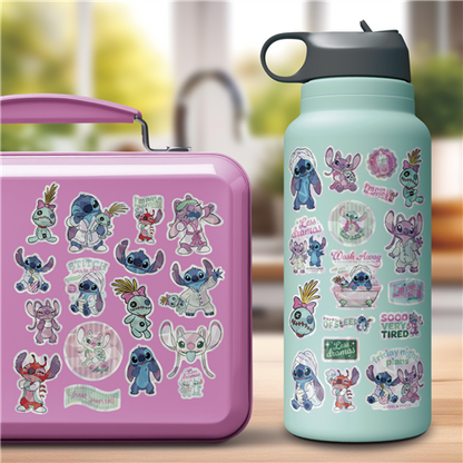 Pink lunch box and teal water bottle with cartoon character stickers on a blurred background
