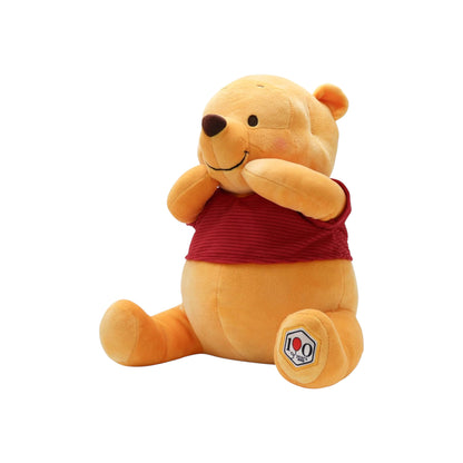 Disney Winnie the Pooh 100th Anniversary Pooh plush, sitting with paws on cheeks, wearing a red corduroy shirt with a 100 Years patch.