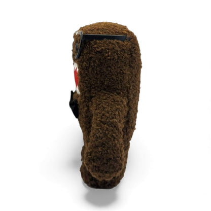 Side view of the 6.5-inch Domo plush dressed as a nerd, wearing thick black glasses with tape on the bridge and a black bow tie.