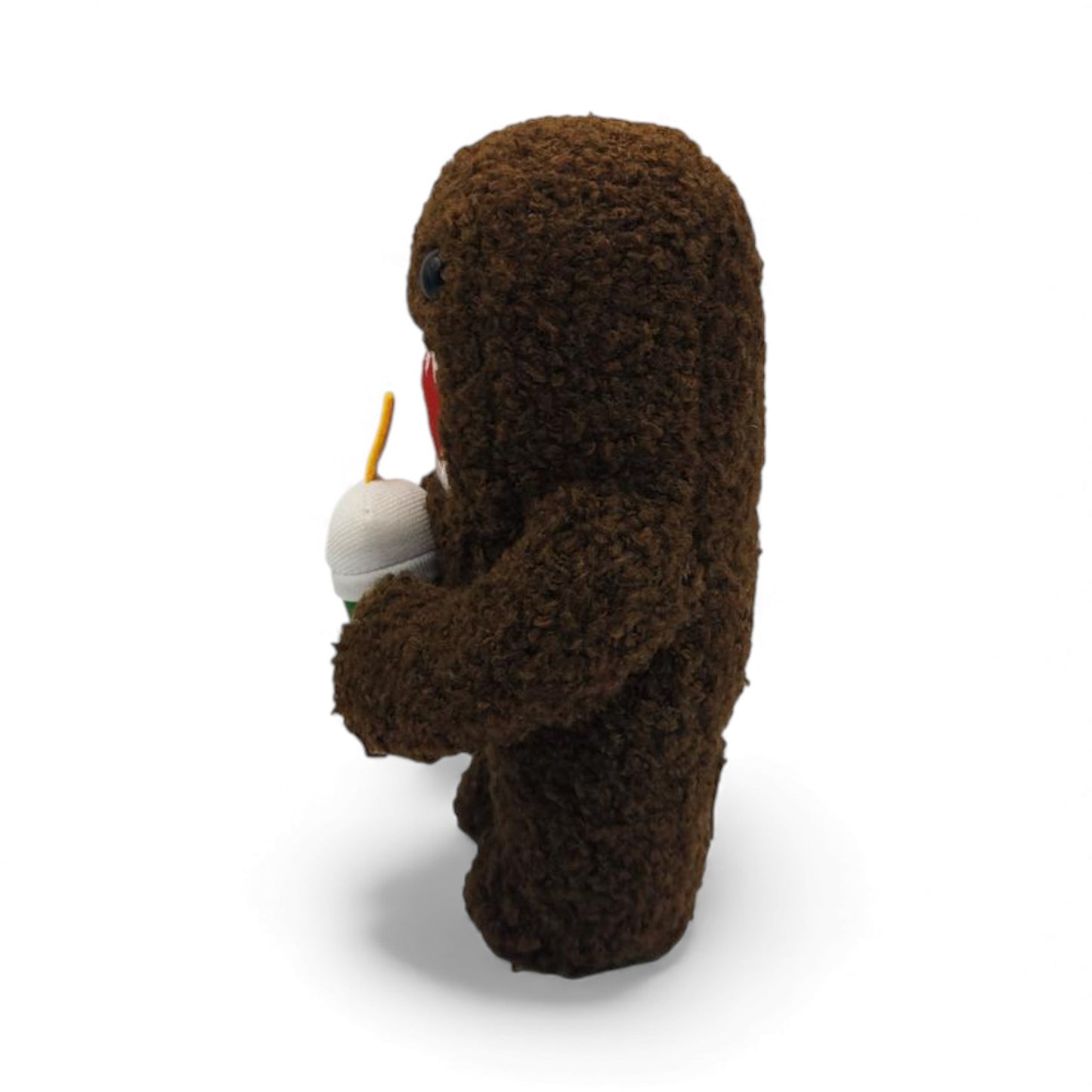 Other side view of the 6.5-inch Domo plush, a brown fuzzy rectangular monster with a large open mouth holding a green boba tea cup.