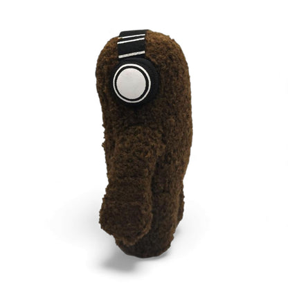 Side view of the 6.5-inch Domo plush, a brown fuzzy monster wearing black
and white headphones.