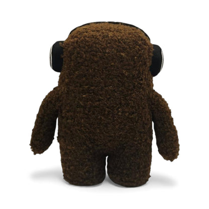 Back view of the 6.5-inch Domo plush, a brown fuzzy monster wearing black
and white headphones.