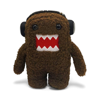 Product view of the 6.5-inch Domo plush, a brown fuzzy monster wearing black and white headphones.