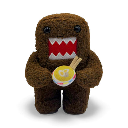 Product view of the 6.5-inch Domo plush, a brown fuzzy monster with an open mouth holding a bowl of ramen noodles with chopsticks.