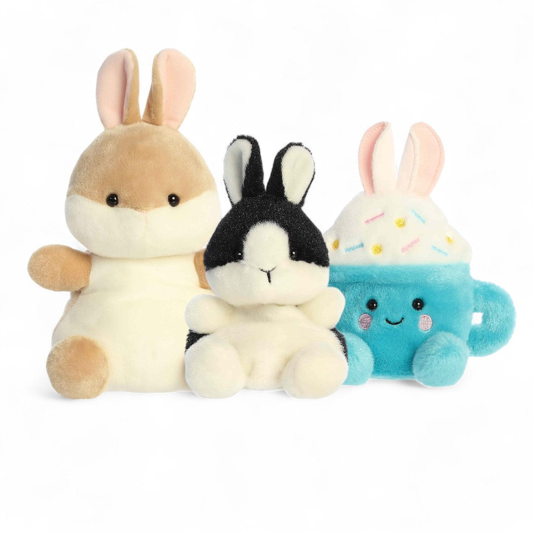 Three plush toys resembling bunnies on a white background