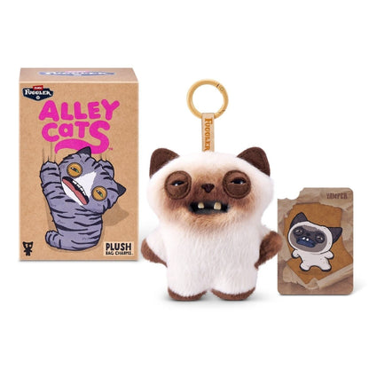 ZURU Fuggler Alley Cats blind box packaging alongside an assortment of plush bag charms featuring human-like teeth.