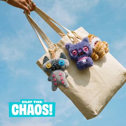 Tote bag with plush toys against a blue sky