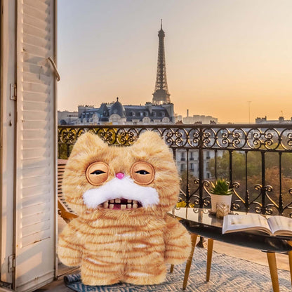 Fuggler Alley Cats Stinkface plush with a Parisian balcony and Eiffel Tower in the background