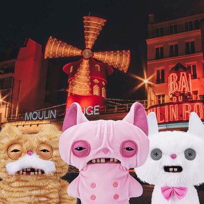 Three Fuggler Alley Cats characters in front of a Moulin Rouge windmill at night.