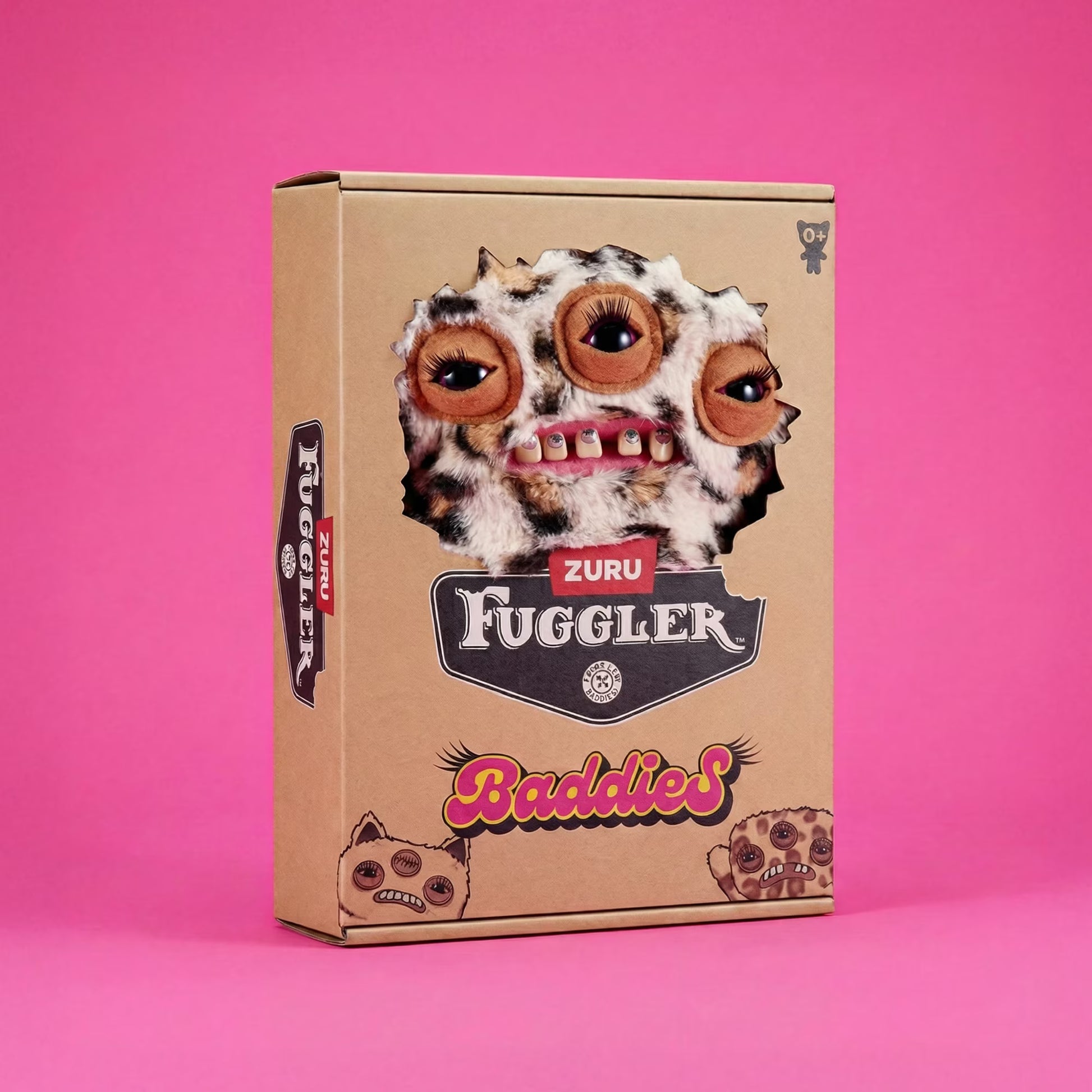 A cardboard product box for Zuru Fuggler Baddies, featuring a cartoon monster face with three eyes and teeth ripped out of the box, set against a solid pink background.