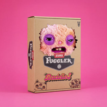 A cardboard product box for Zuru Fuggler Baddies, featuring a die-cut window showing a fuzzy pink monster face with purple eyes, set against a solid pink background.