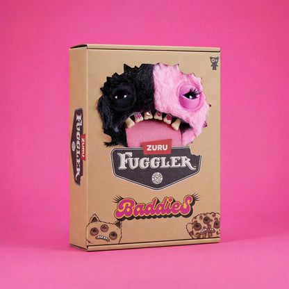 A cardboard product box for the Zuru Fuggler Baddies, featuring a graphic of a split black-and-pink monster face on the front, set against a solid pink background.