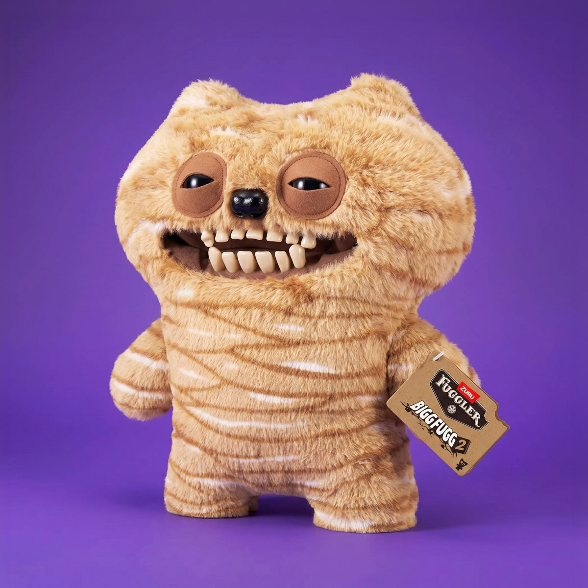 Fuggler Bigg Fugg Chuckles 18-Inch Plush featuring fuzzy tan and white striped fur, a wide mouth with human-like teeth, and heavy-lidded eyes.