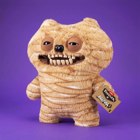 Fuggler Bigg Fugg Chuckles 18-Inch Plush featuring fuzzy tan and white striped fur, a wide mouth with human-like teeth, and heavy-lidded eyes.