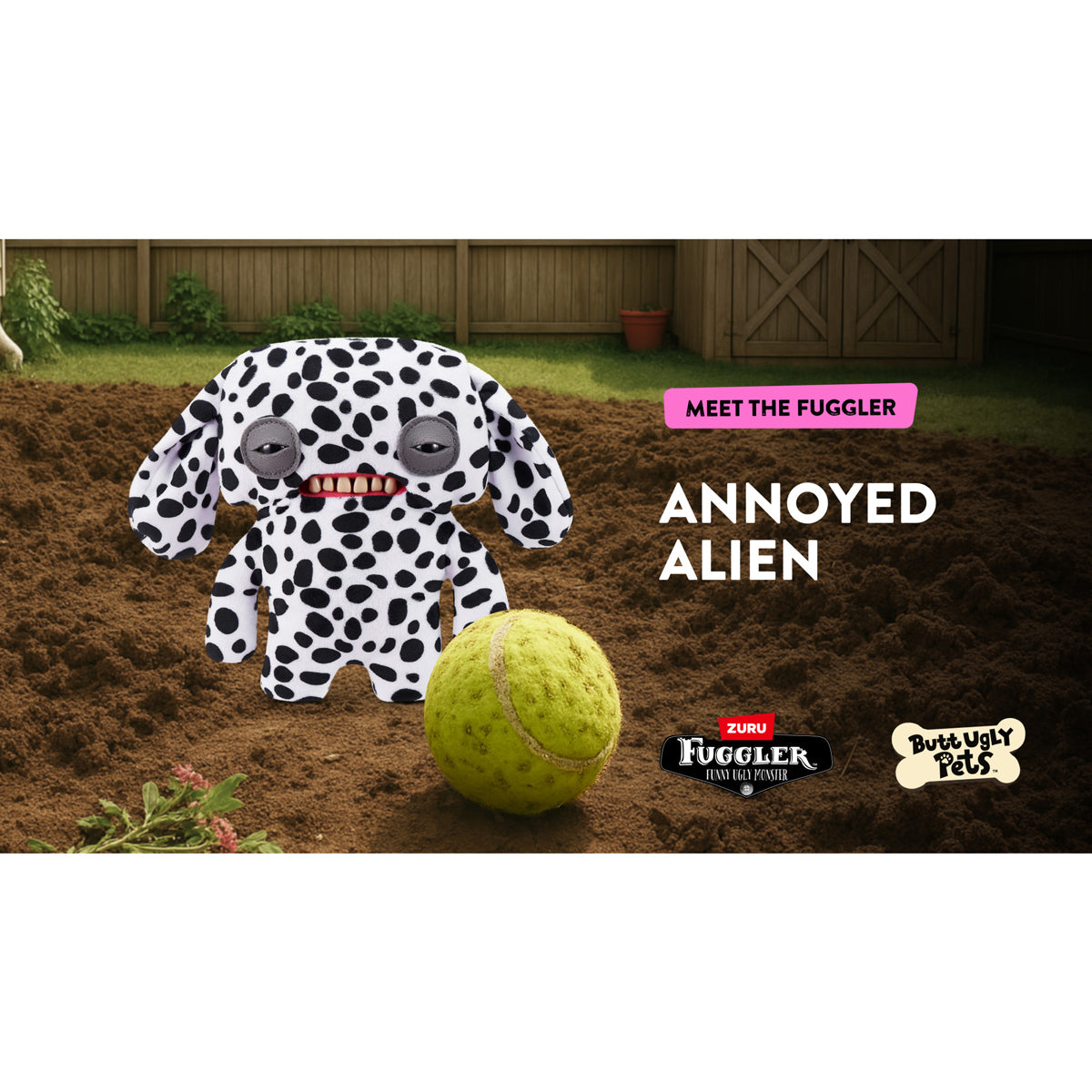 A 9-inch Fuggler Butt Ugly Pet (Annoyed Alien Dalmatian) plush toy. It has white fabric with black Dalmatian spots, long floppy ears, squinting grey eyelids, and a mouth with realistic human teeth. It is on a dug out grass landscape with a tennis ball and "Meet the Fuggler" and Zuru brandings text. 