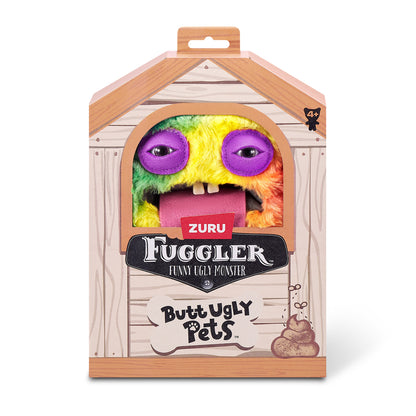 A 9-inch Fuggler Butt Ugly Pet (Cheeky Chonky Guinea Pig) plush toy. It has shaggy rainbow-colored fur, pointy purple ears, squinting purple eyelids, two human-like teeth, and a large pink felt tongue sticking out in a display box. 