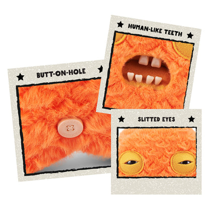 Close up features of A 9-inch Fuggler Butt Ugly Pet (Cod Father Gold Fish) plush toy. It is shaggy and orange, shaped like a fish, with side fins, squinting yellow-lidded eyes, and a mouth with realistic human teeth.