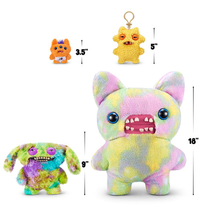 A Fuggler size comparison chart for A 9-inch Fuggler Butt Ugly Pet (Count Underoo McGoo Cockapoo) plush toy. It has shaggy, multi-colored tie-dye fur (green, blue, purple), long floppy ears, squinting purple eyelids, and a wide mouth full of realistic human teeth.