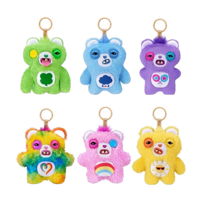Fuggler Care Bears blind box packaging alongside an assortment of plush bag charms featuring Care Bear designs and human-like teeth.