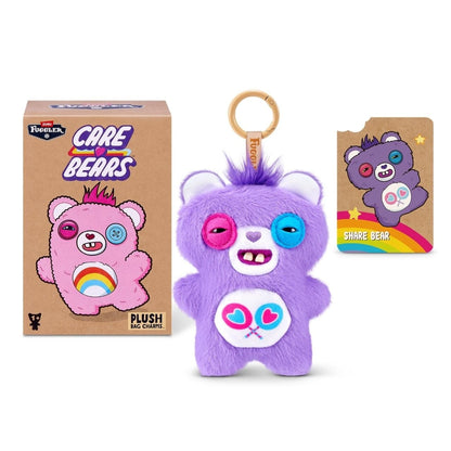 Fuggler Care Bears blind box packaging alongside an assortment of plush bag charms featuring Care Bear designs and human-like teeth.
