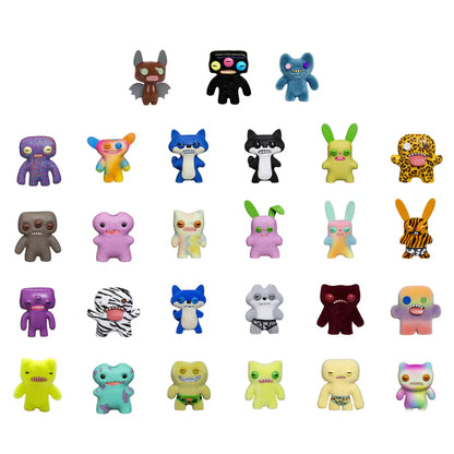 An array of 24 different colourful Fuggler mini collectible figures with various designs, expressions, and signature teeth showing.