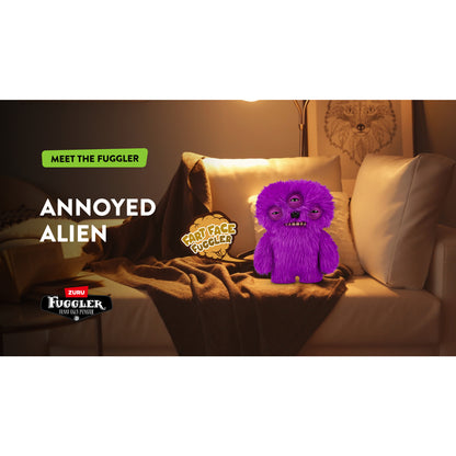 Purple plush toy with a face on a couch, labeled 'Annoyed Alien', in a cozy living room setting. Fuggler Fart Face Annoyed Alien Plush by ZURU, Series 1