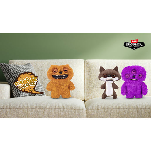Four fluffy toys on a couch with a green wall background, featuring the Fuggler logo. Fuggler Fart Face Count Underoo Mcgoo Plush by ZURU, Series 1
