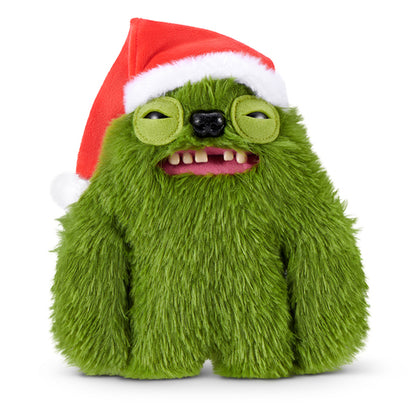 Fuggler Festive Fuggs Series 2 green Sasquinch 9-inch plush showing wide human-like teeth and wearing a red Santa hat.