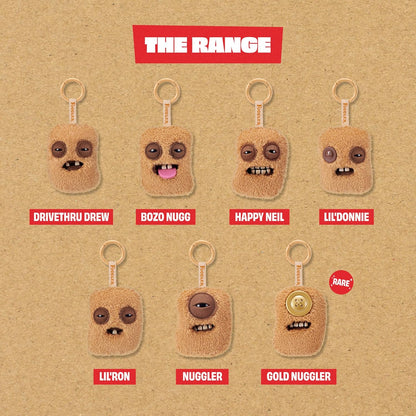 Seven variations of Fuggler Fugg Nuggets plush keyrings featuring funny-ugly monster faces with human-like teeth on fuzzy chicken nugget shapes.