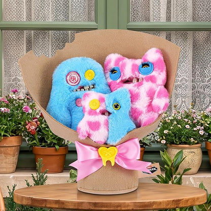 Fuggler Fugg Bouquets Plush Set featuring two 9-inch and one 3.5-inch blue and pink monster plush toys wrapped in craft paper with a pink ribbon.