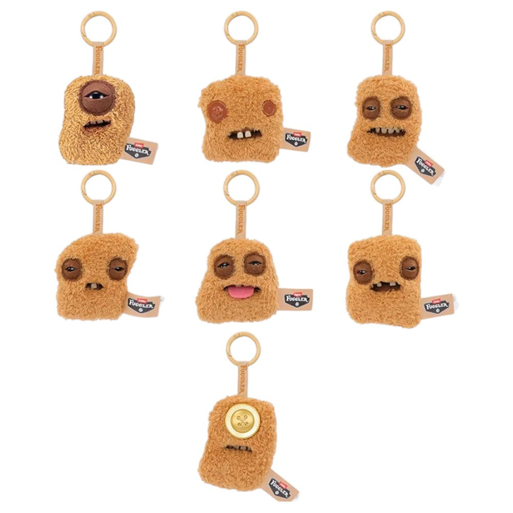 Seven variations of Fuggler Fugg Nuggets plush keyrings featuring funny-ugly monster faces with human-like teeth on fuzzy chicken nugget shapes.